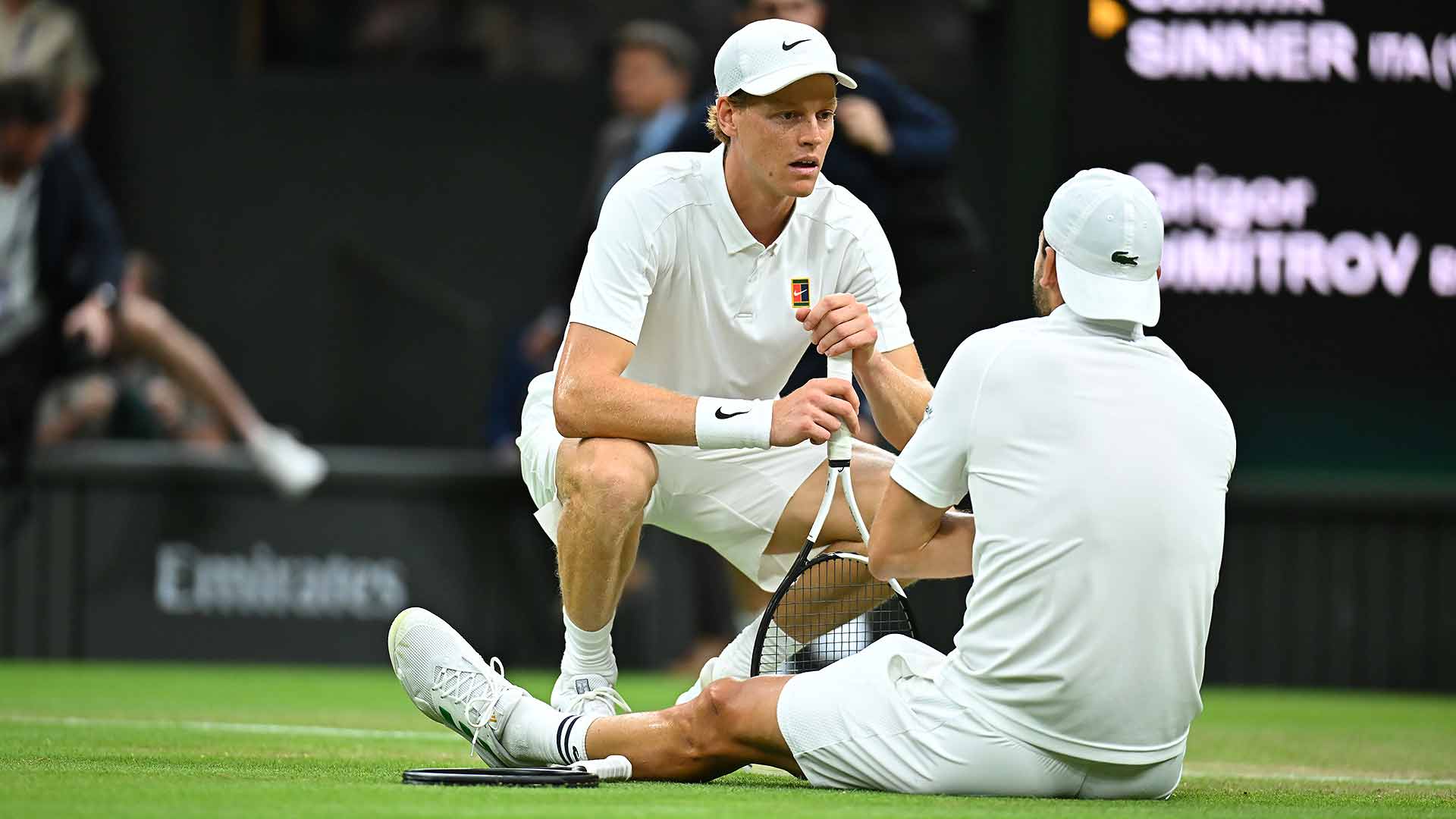 Jannik Sinner comforts an injured Grigor Dimitrov at the conclusion of their fourth-round Wimbledon match Monday.