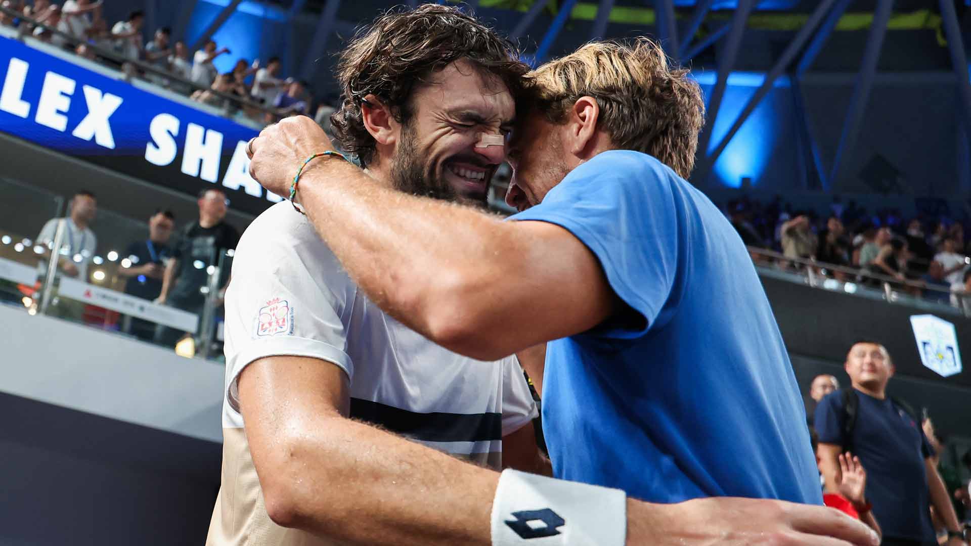Valentin Vacherot celebrates his Shanghai triumph with coach and half-brother Benjamin Balleret.